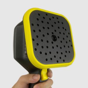 A hand holding a black and yellow steam cleaner with a perforated square nozzle.